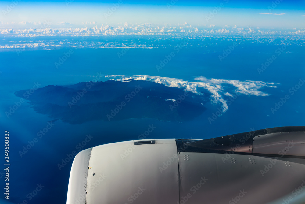 Blue sky, island, sea and jet engine Blue sky, island, sea and jet engine