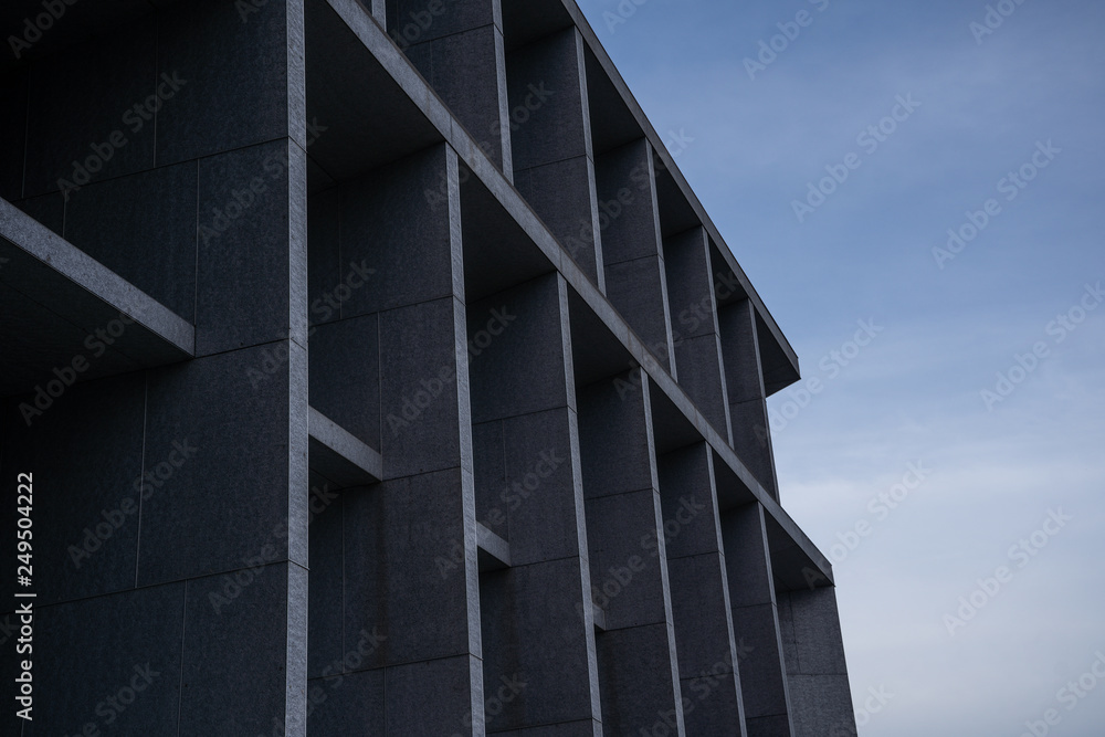 Fototapeta premium empty square stone wall building with blue sky in the background