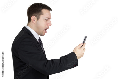 Businessman in Black Suit Holding Smartphone in Hand And Feeling Angry Against White Background © ArtmediaworX