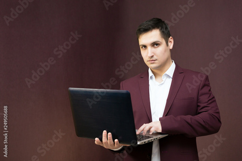Young successful businessman with a laptop in hand.