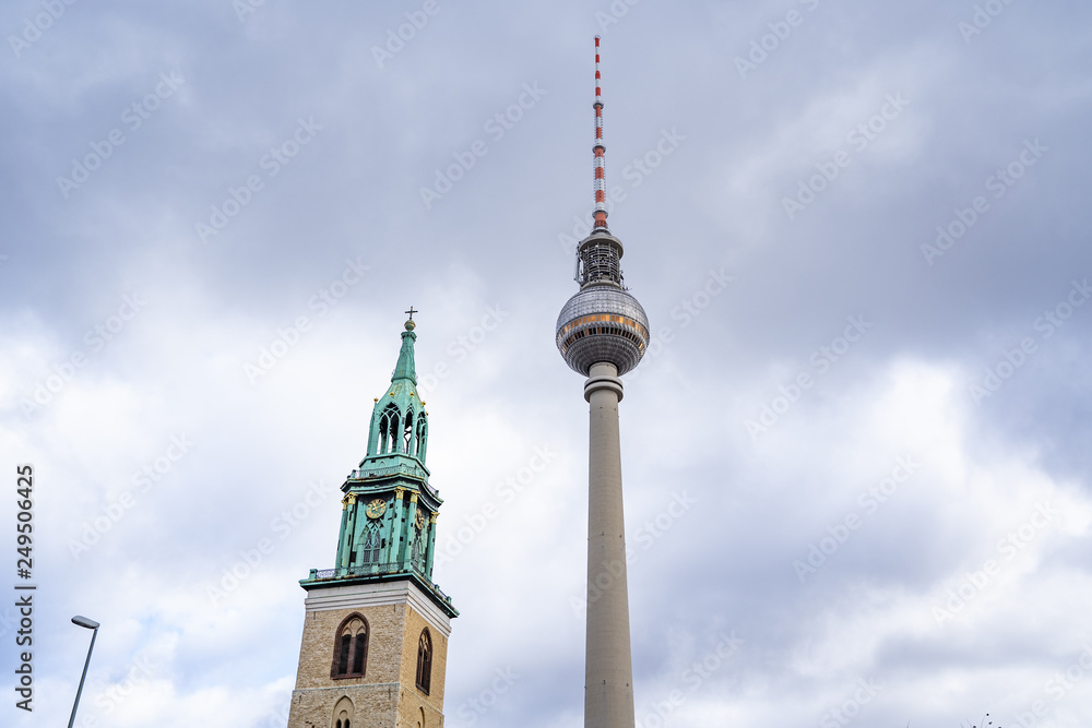 tv tower Berlin isolated on natural blue sky background, The TV Tower located on the Alexanderplatz in Berlin, Germany, tv tower with the st. Mary church in berlin