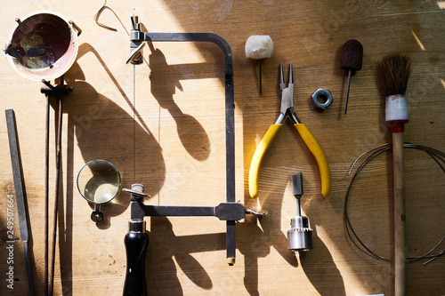 Tools set for handmade jewellery. Jewelry workplace on wooden background. Top view.