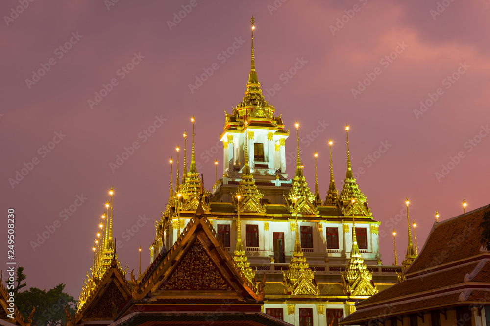 The top of Chedi Loha Prasat in the night illumination. Buddhist temple Wat Ratchanatdaram Woravihara , Bangkok The top of Chedi Loha Prasat in the night illumination. Buddhist temple Wat Ratchanatdaram Woravihara , Bangkok