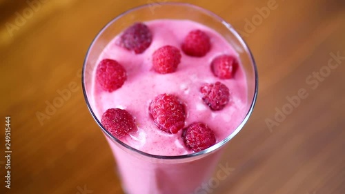 sweet organic smoothie with raspberry on wooden photo