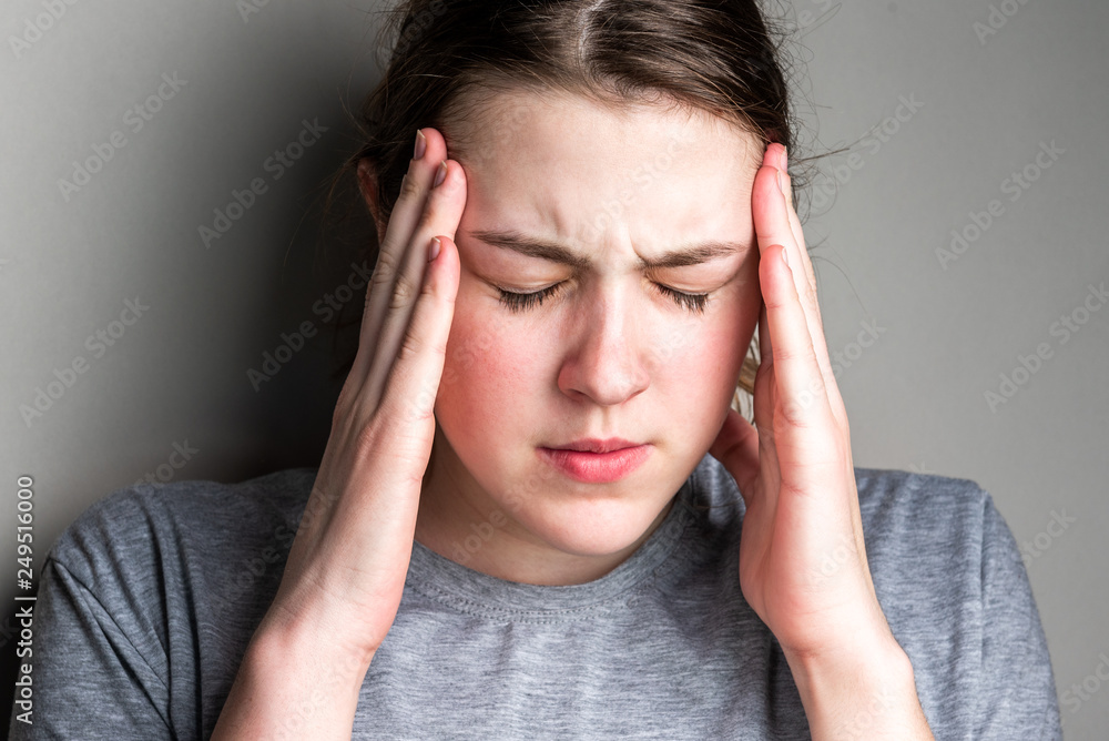 Headache in the temples. Sick girl suffering from head migraine, feeling pressure and stress. Headache in the temples. Sick girl suffering from head migraine, feeling pressure and stress.