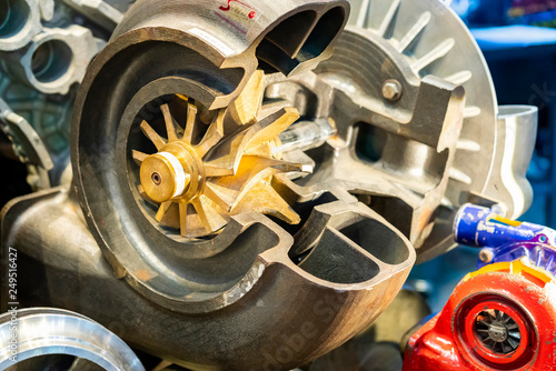 close up impeller gold color or brass and detail inside of cross section industrial centrifugal pump or high pressure blower photo