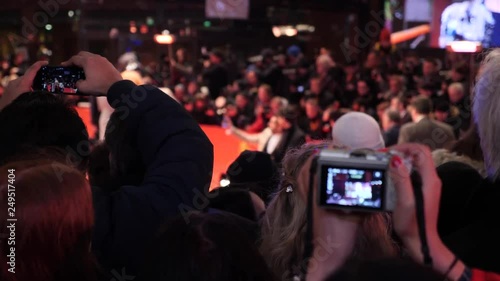 Crowd and fans taking photographs on mobile phones at a red carpet film festival event photo