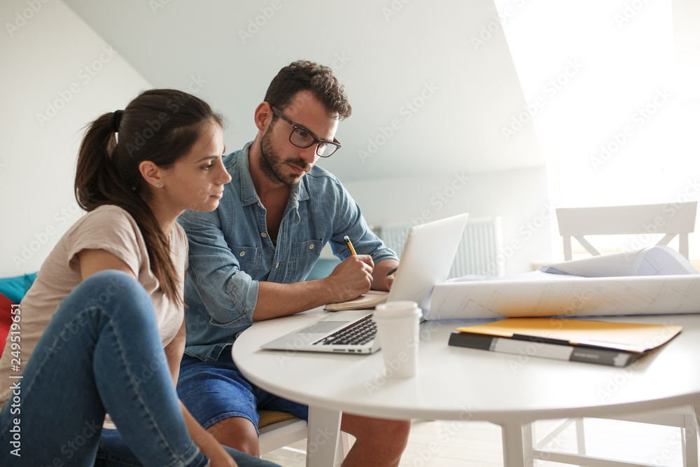 Husband and wife sitting at home and buying online stocks actions. Husband and wife sitting at home and buying online stocks actions.