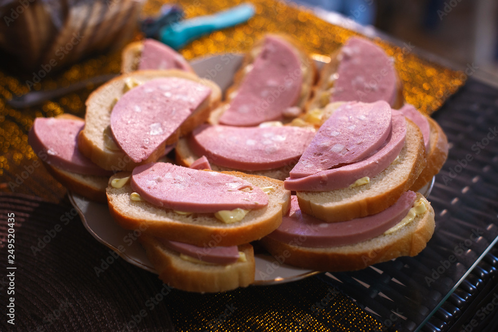Sandwiches with boiled sausage on a plate