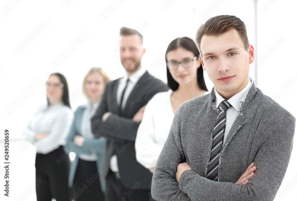 young businessman standing in front of his business team young businessman standing in front of his business team