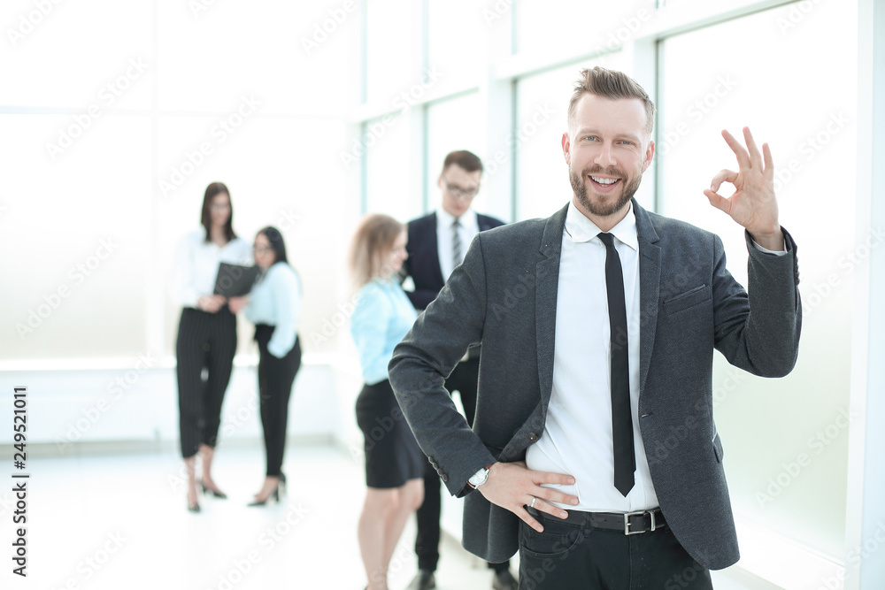 smiling successful business man showing OK gesture smiling successful business man showing OK gesture