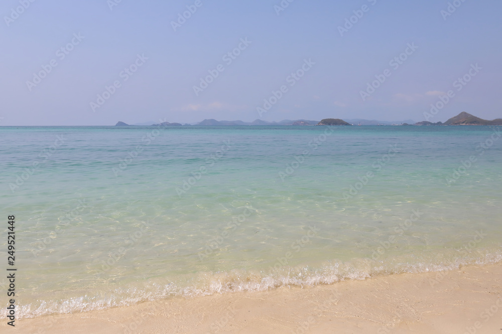 Beautiful sandy beach and soft blue ocean wave