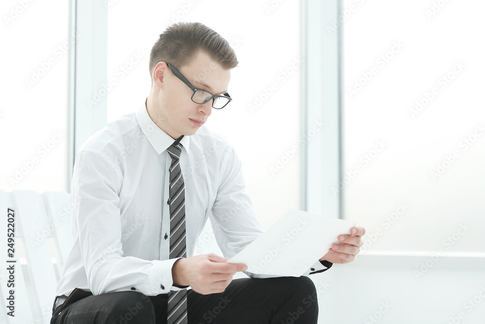 businessman reading a business document sitting in the office businessman reading a business document sitting in the office