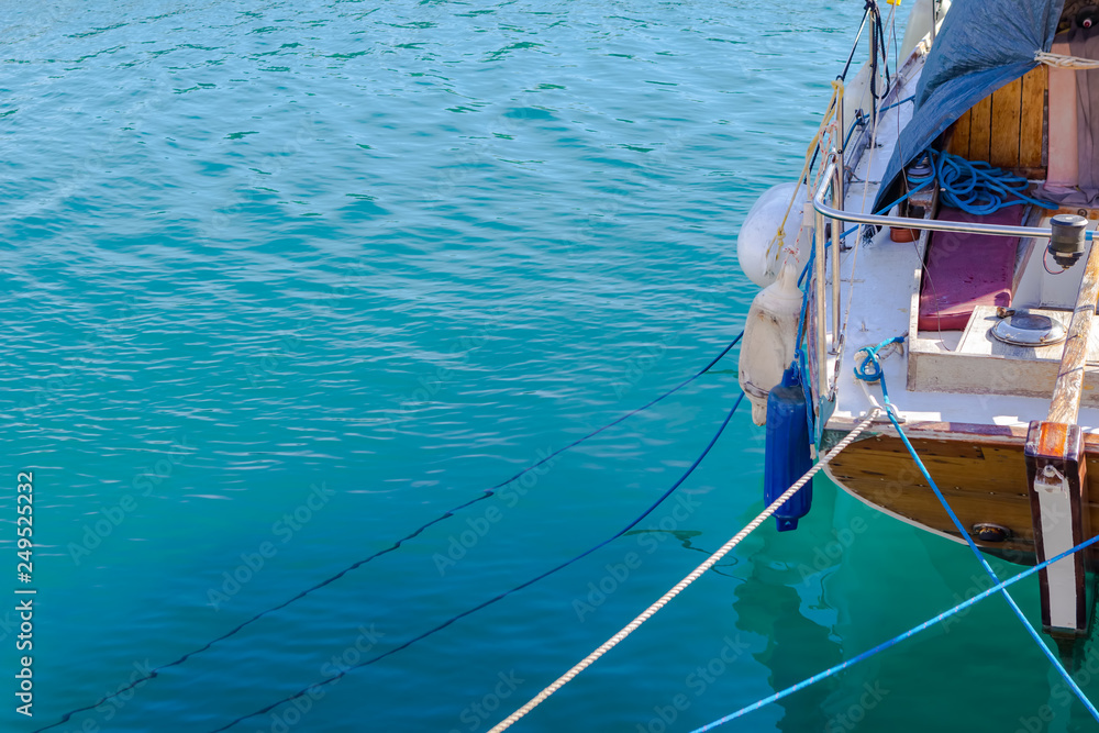 Boat part on bright blue shallow sea in Greece