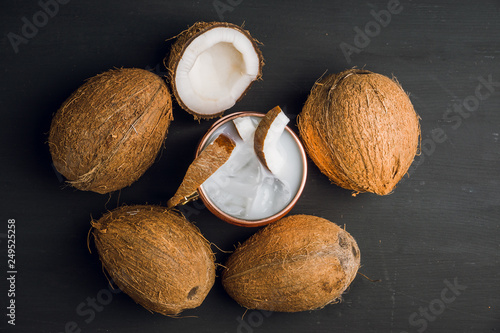 Sweet coconut cocktail in copper mug (variation of Moscow mule) on the wooden background. Selective focus. Shallow depth of field.  photo