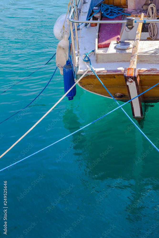 Boat part on bright blue shallow sea in Greece