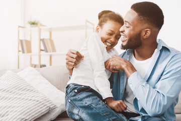 Father and daughter playing together at home