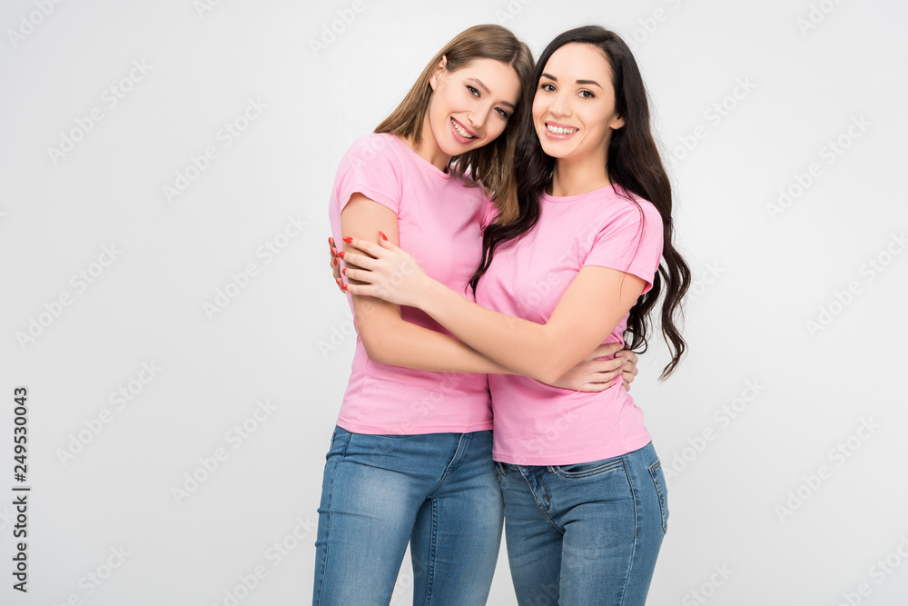 cheerful girls standing and hugging isolated on grey cheerful girls standing and hugging isolated on grey