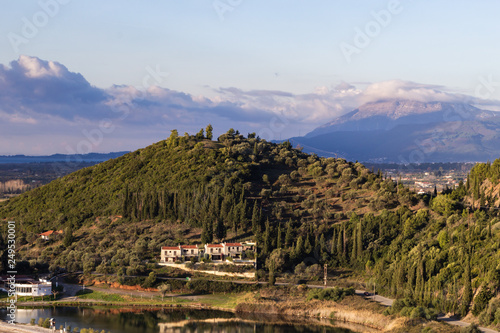 Rolling hills and lagoon near Greek sea.