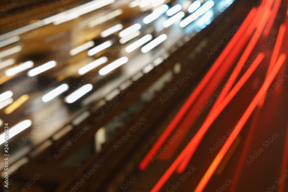 The lights of blurred motion at the highway. Long exposure of urban night traffic.