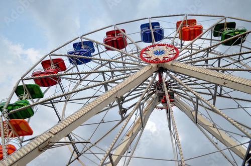 A colorful ferris wheel viewed from below