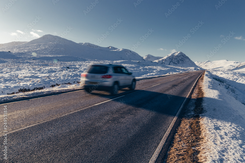Car driving on open road winter snow mountain landscape in Glencoe ...