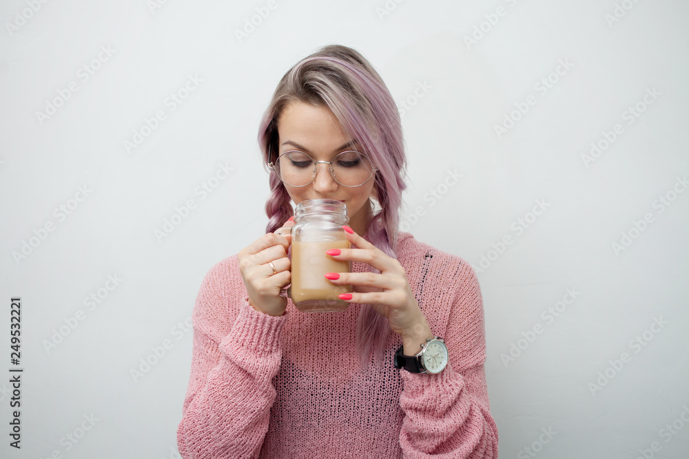 Trendy young woman drinking coffee milkshake. Girl with jar-mug on Trendy young woman drinking coffee milkshake. Girl with jar-mug on