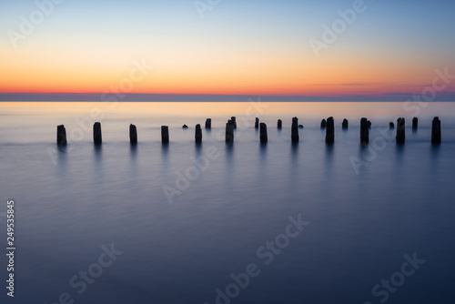 Stakes on the Baltic sea at sunset time, Karwia village, Poland