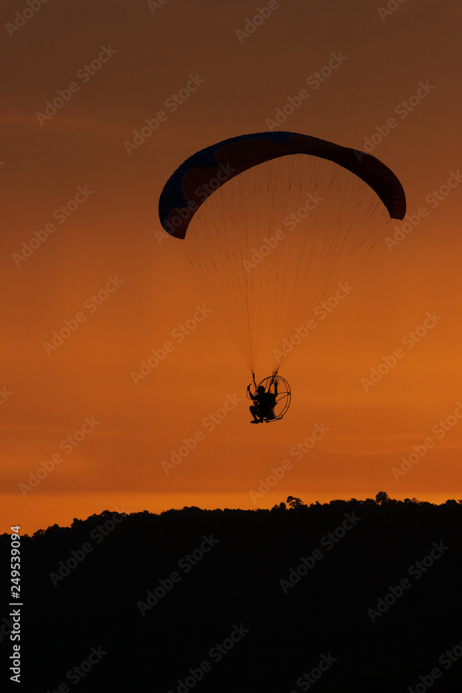 silhouette of paraglider at sunset silhouette of paraglider at sunset