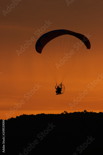 silhouette of paraglider at sunset