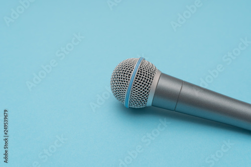 Vocal microphone in the right on light-blue background