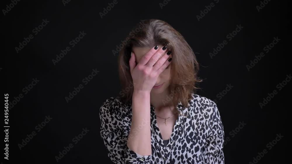 Closeup portrait of adult caucasian female getting annoyed and embarrassed clapping her head with a hand Closeup portrait of adult caucasian female getting annoyed and embarrassed clapping her head with a hand