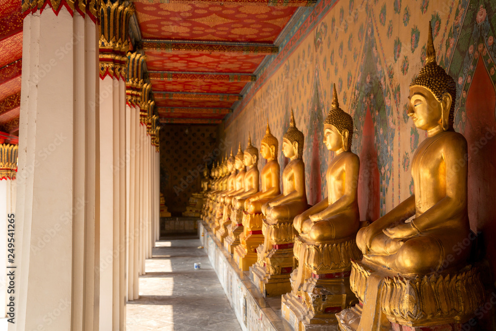 Row of golden buddha statue at Wat Arun, Bangkok Thailand.