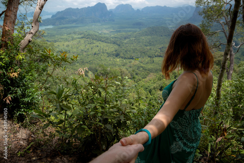 The girl leads the photographer to show a stunning view. follow me