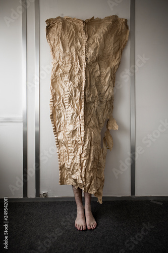 Une personne debout derrière une texture en papier