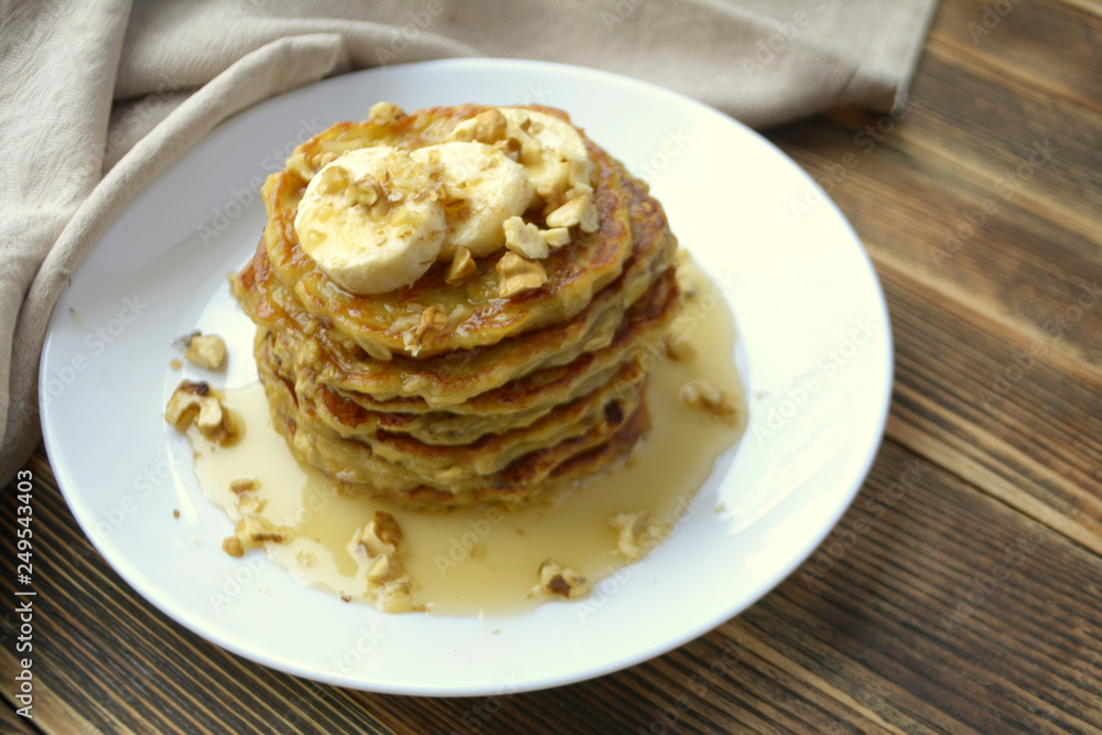 Stack of oatmeal pancake with banana, nuts and honey Healthy Breakfast Stack of oatmeal pancake with banana, nuts and honey Healthy Breakfast