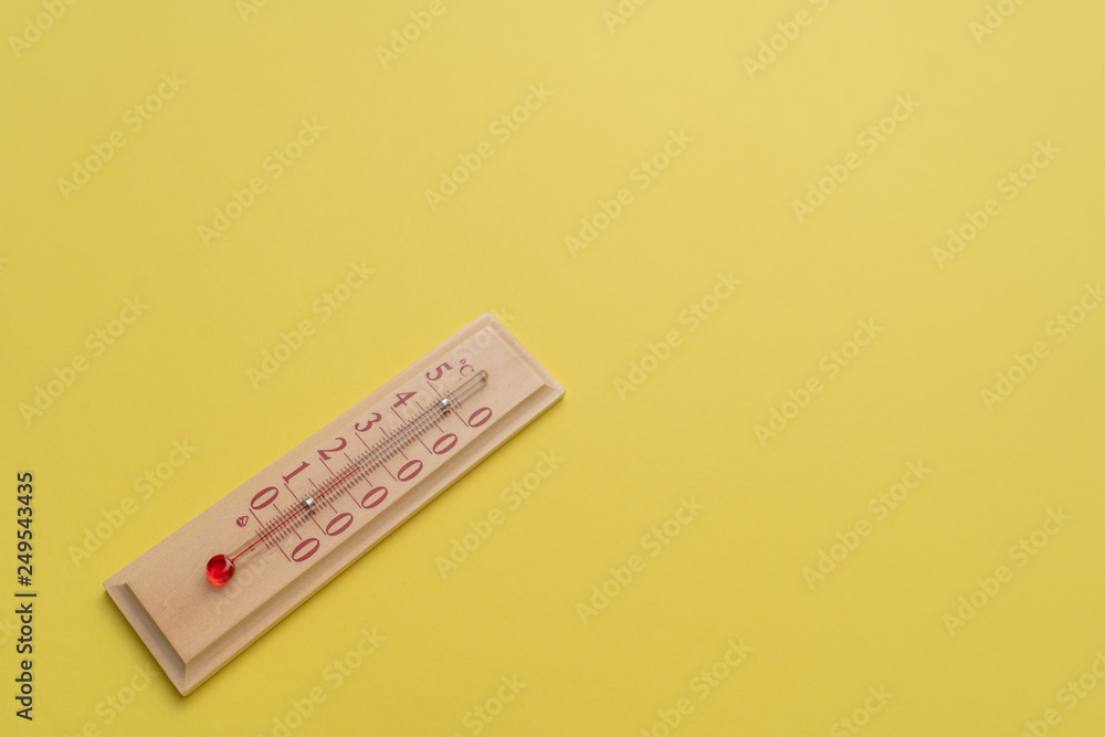 Room thermometer is located diagonally on a yellow background. Room thermometer is located diagonally on a yellow background.