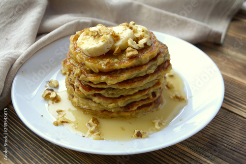 Stack of oatmeal pancake with banana, nuts and honey Healthy Breakfast	