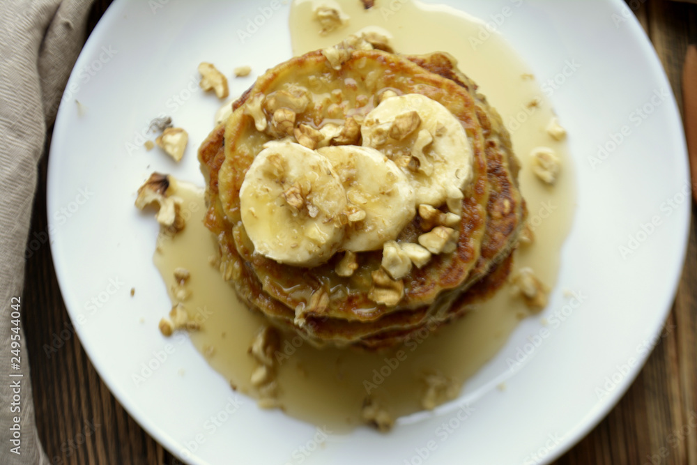 Stack of oatmeal pancake with banana, nuts and honey Healthy Breakfast Stack of oatmeal pancake with banana, nuts and honey Healthy Breakfast