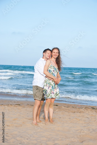 Image of couple hugging by the sea in Spain on their honeymoon. Happy family vacation. © Etnika