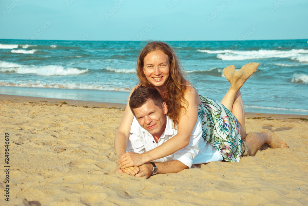 Couple of  lovers  on sea shore. Honeymoon vacation on the beach. Happiness in the air.