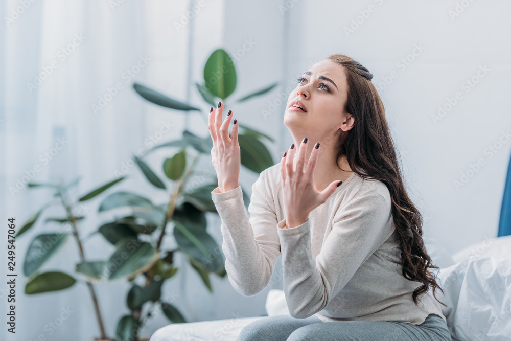 frustrated woman gesturing with hands and grieving at home frustrated woman gesturing with hands and grieving at home