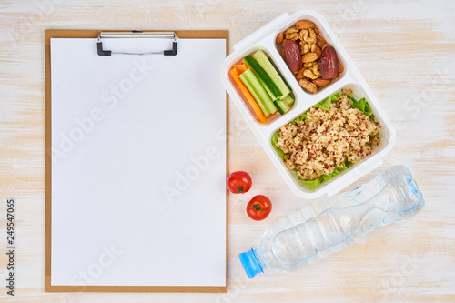 Clipboard, vegan lunch box, bottle. Healthy vegetarian menu, weight loss, healthy lifestyle