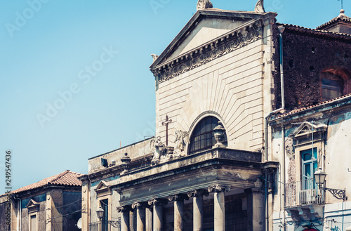 Facade of old cathedral on historical street of Catania, Sicily, Italy.