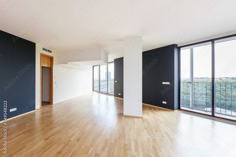 Modern white empty loft apartment interior with parquet floor with black column and panoramic windows, Overlooking the metropolis city