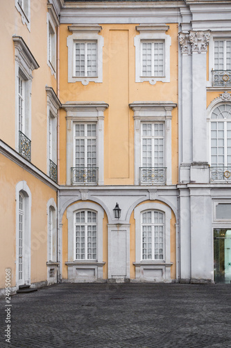 Architectural Details on classical styled building with yellow and white trim © littleny