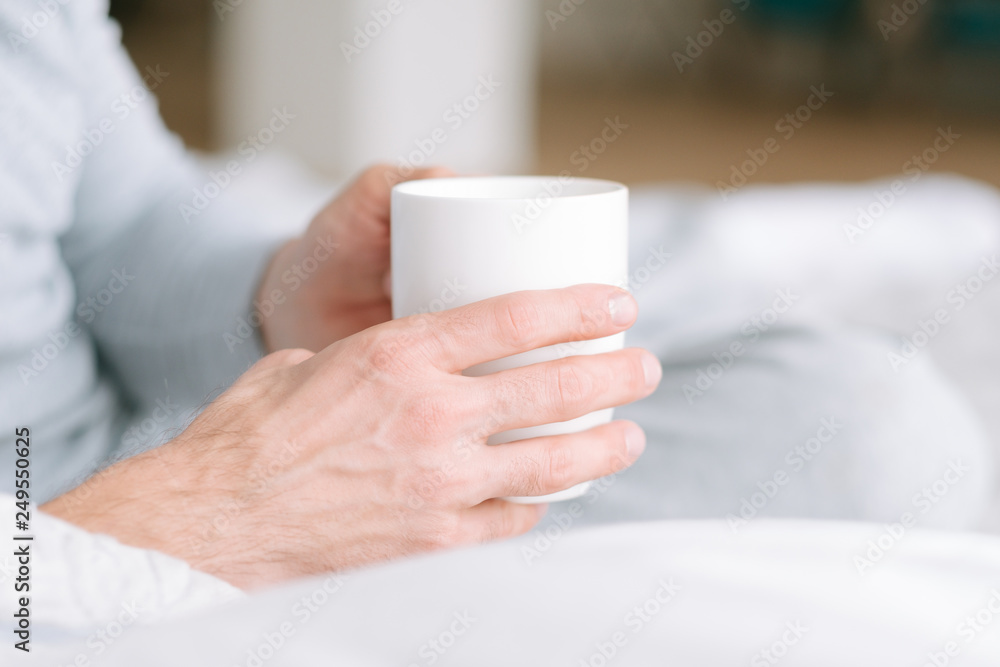 Favourite comfort beverage. Healthy habit. Man hands with cup of hot drink. Close up. Favourite comfort beverage. Healthy habit. Man hands with cup of hot drink. Close up.