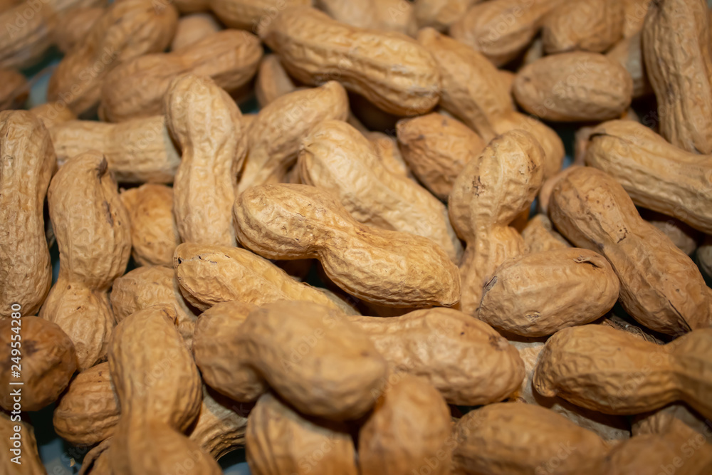 The pile of peanuts on the table, healthy snack closeup The pile of peanuts on the table, healthy snack closeup