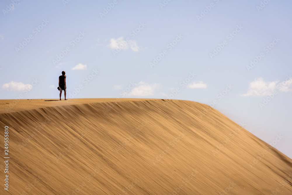 Obraz premium woman walking on dunes in maspalomas, spain