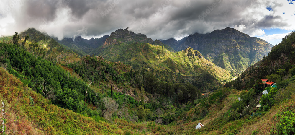 Beautiful 180 degree panoramic landscape panorama of the mountains of Madeira on a cloudy summer day